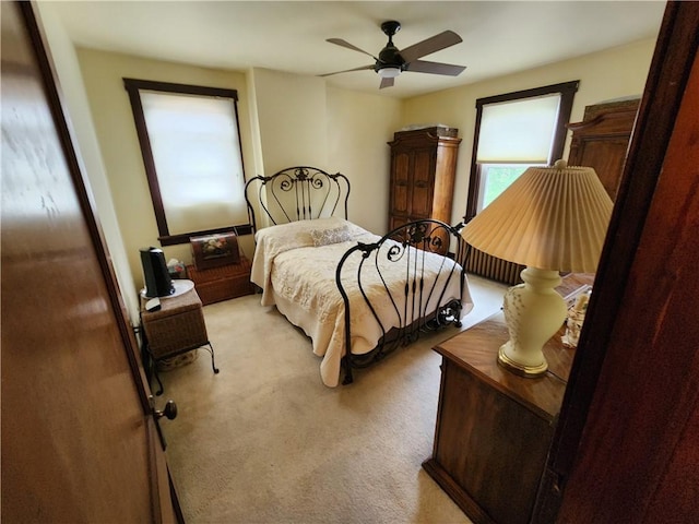 bedroom featuring ceiling fan and light carpet
