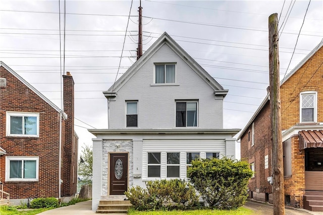 american foursquare style home featuring brick siding