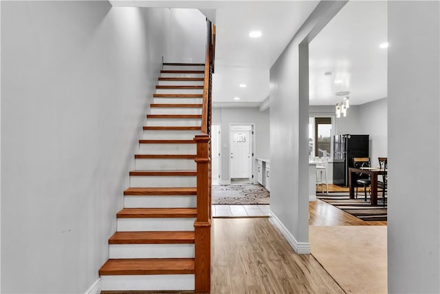 stairs featuring baseboards, recessed lighting, and wood finished floors