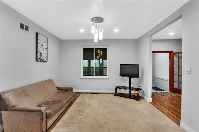 living area with baseboards, recessed lighting, wood finished floors, and visible vents