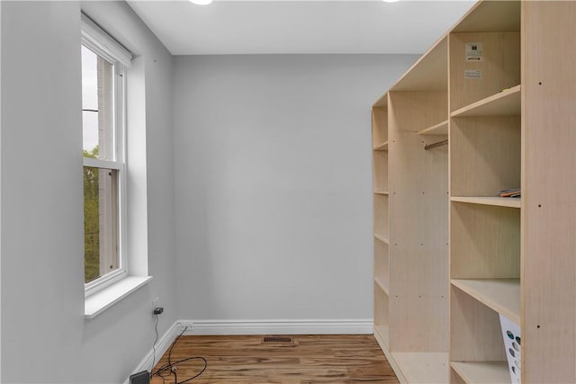 spacious closet with wood finished floors