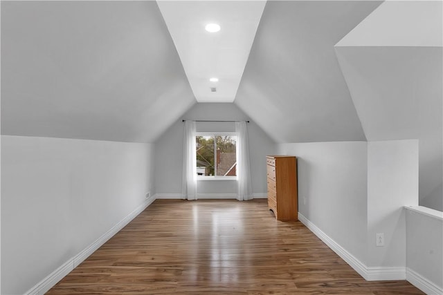 bonus room featuring baseboards, recessed lighting, lofted ceiling, and wood finished floors