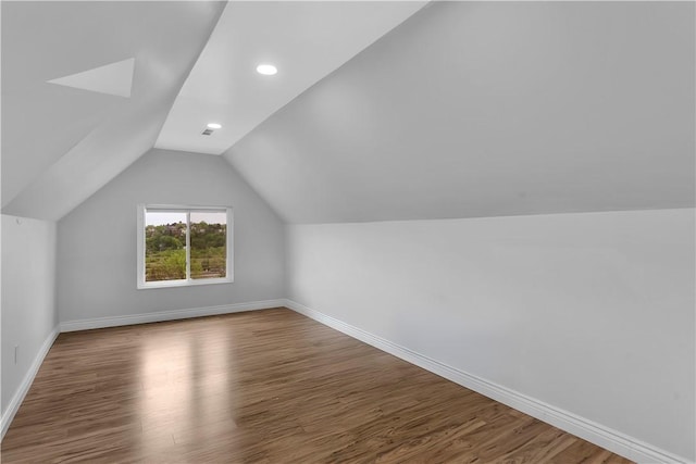 additional living space with recessed lighting, baseboards, wood finished floors, and lofted ceiling