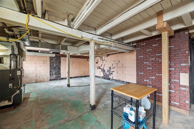 unfinished below grade area featuring heating unit