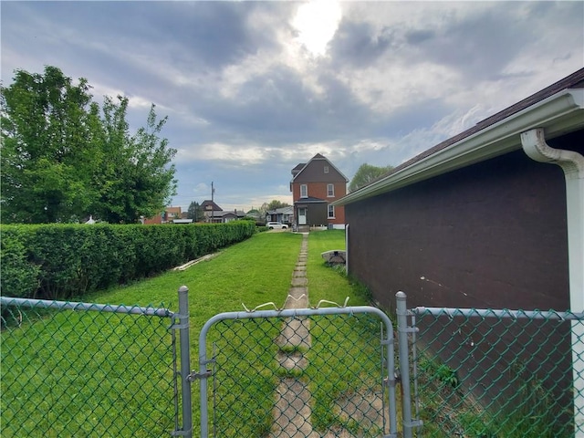view of yard featuring fence and a gate