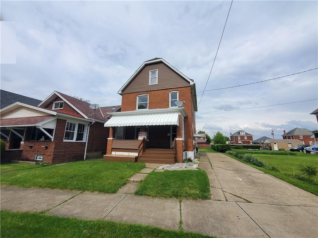 view of front of home featuring brick siding and a front yard