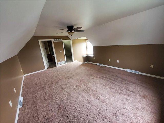 additional living space featuring baseboards, ceiling fan, lofted ceiling, and visible vents