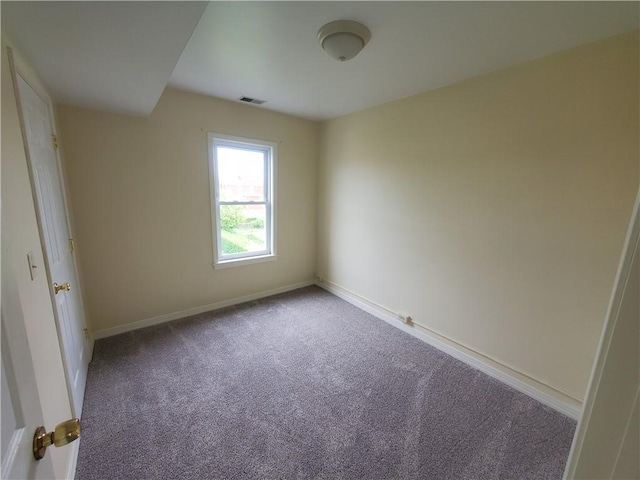 carpeted empty room featuring baseboards and visible vents