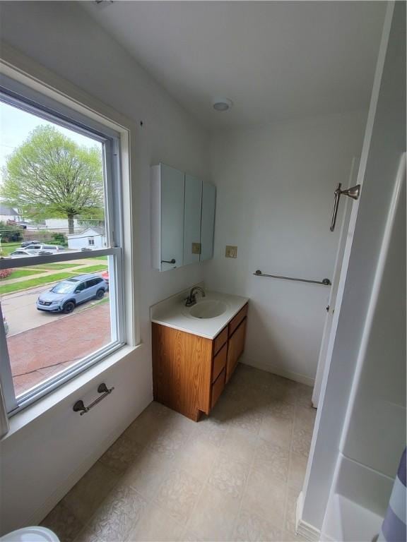 bathroom with a healthy amount of sunlight and vanity