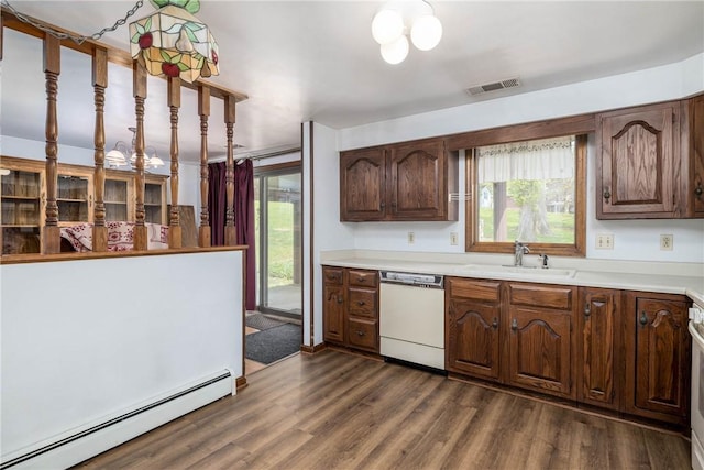 kitchen featuring visible vents, a sink, white dishwasher, light countertops, and a baseboard radiator