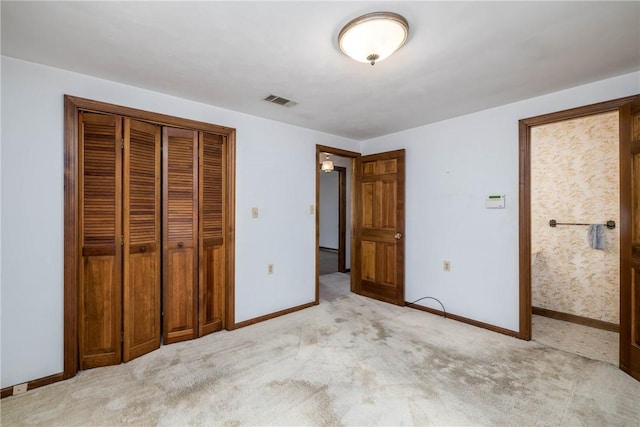 unfurnished bedroom with visible vents, carpet, baseboards, and a closet