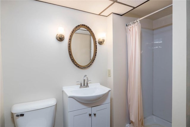 full bathroom featuring vanity, a stall shower, and toilet