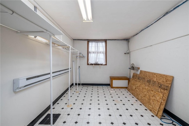 basement featuring baseboards and light floors