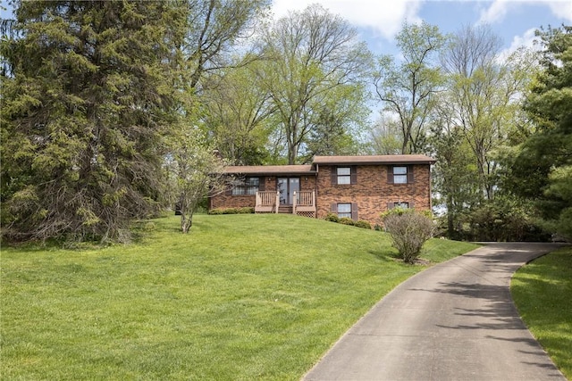 view of front of house with brick siding and a front yard