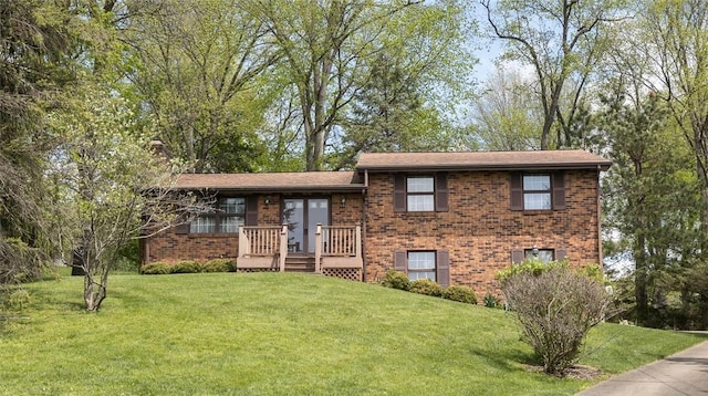 split level home featuring brick siding and a front lawn