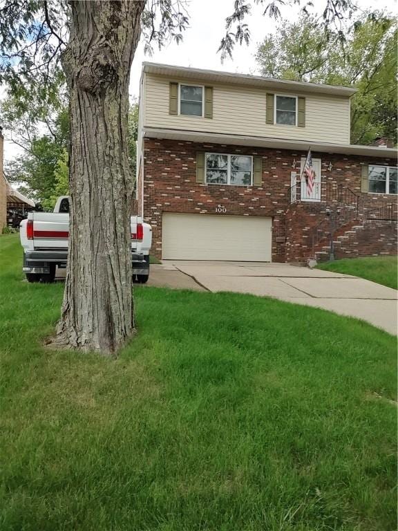 100 Forest Dr, Natrona Hts/Harrison Twp, PA 15065 - view of front of house featuring an attached garage, a front lawn, brick siding, and concrete driveway
