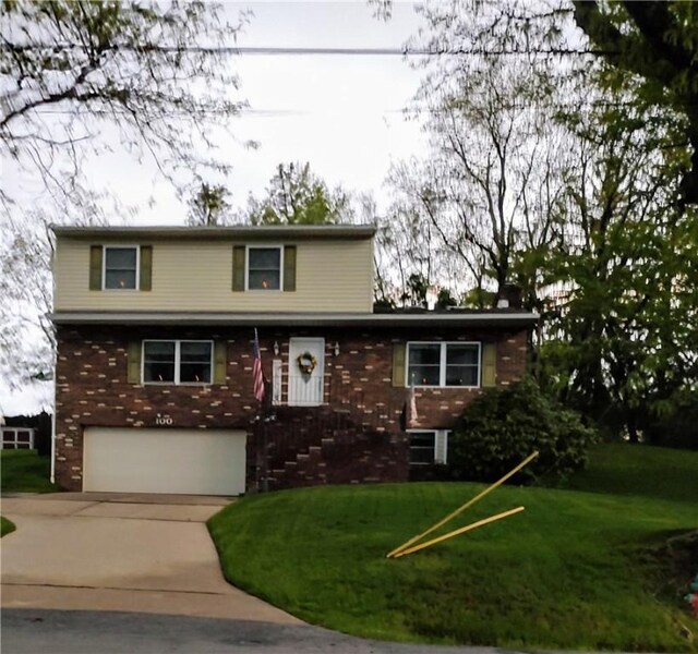 100 Forest Dr, Natrona Hts/Harrison Twp, PA 15065 - traditional-style home with a garage, driveway, brick siding, and a front yard