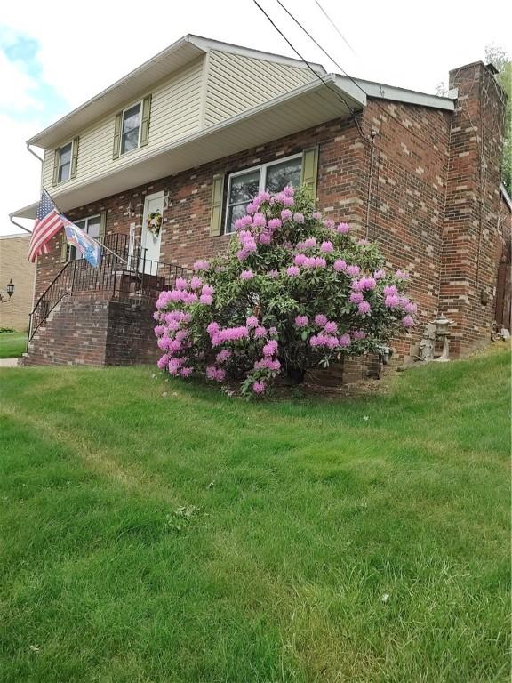100 Forest Dr, Natrona Hts/Harrison Twp, PA 15065 - view of side of home with a lawn and brick siding