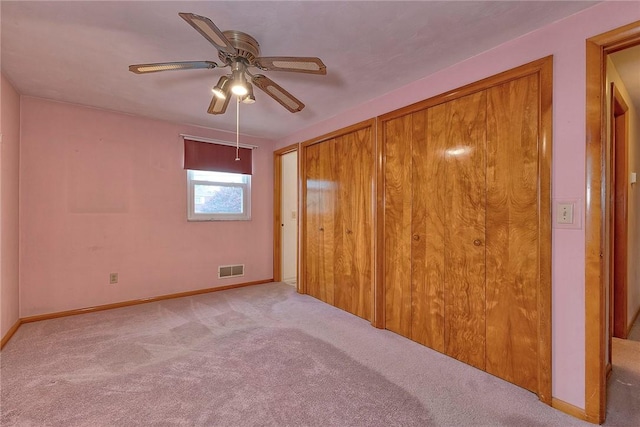1712 Educational Dr, White Oak, PA 15131 - unfurnished bedroom featuring carpet floors, baseboards, ceiling fan, and two closets