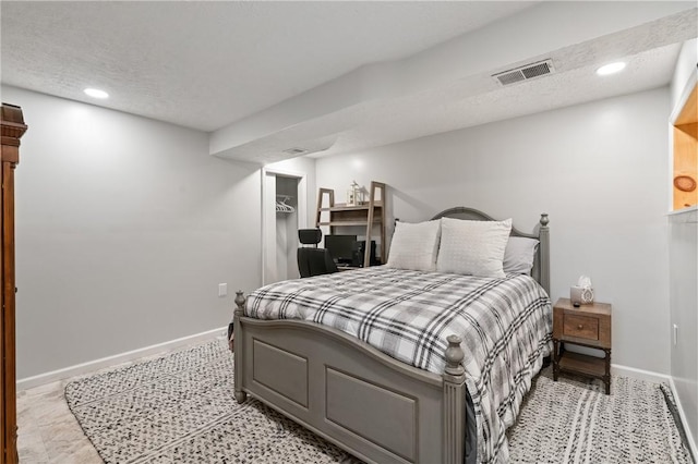 bedroom featuring visible vents, recessed lighting, baseboards, and a textured ceiling