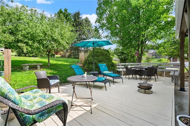 wooden terrace with a yard and outdoor dining space
