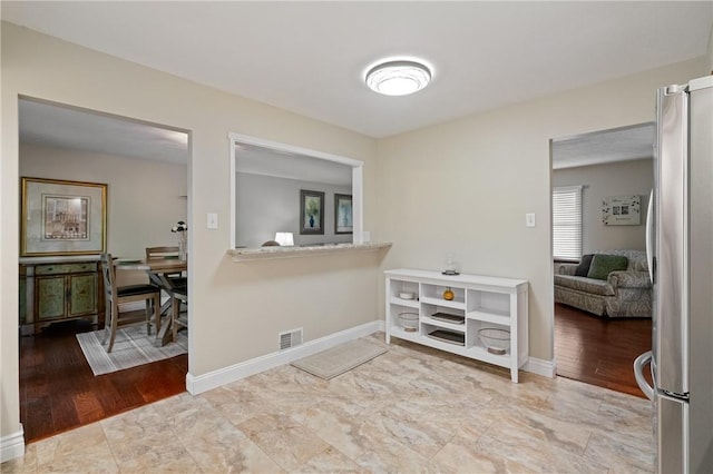 interior space with baseboards and visible vents