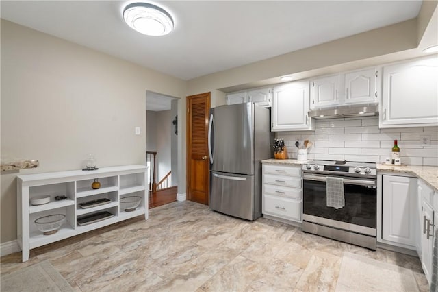 kitchen with light stone counters, white cabinetry, appliances with stainless steel finishes, and under cabinet range hood