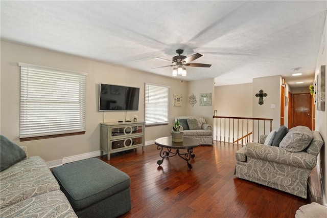 living area featuring a ceiling fan, baseboards, and wood finished floors