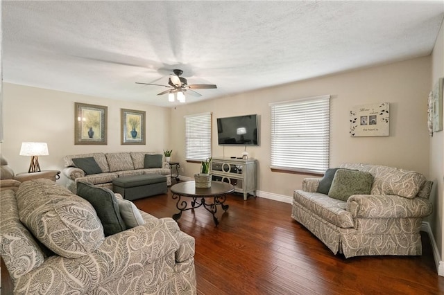 living area with baseboards, ceiling fan, and wood finished floors