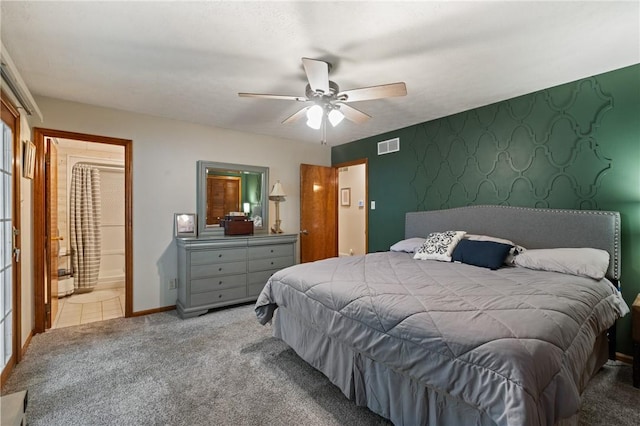 bedroom with visible vents, a ceiling fan, baseboards, ensuite bathroom, and carpet flooring