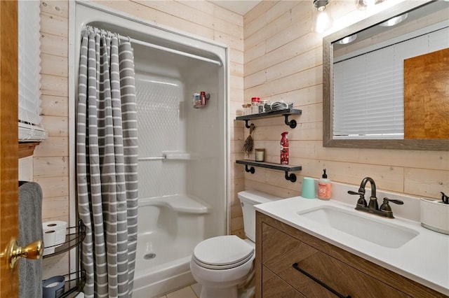 bathroom featuring vanity, wood walls, a stall shower, and toilet