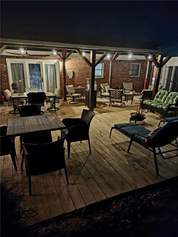 patio at twilight featuring an outdoor living space and a wooden deck