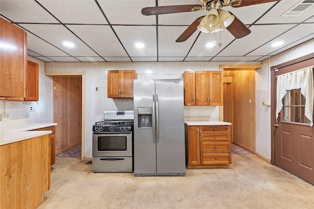 kitchen with light countertops, stainless steel appliances, visible vents, and brown cabinetry