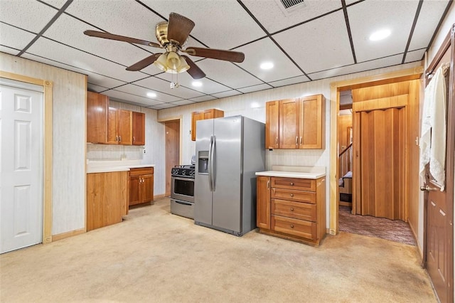 kitchen featuring visible vents, a ceiling fan, stainless steel appliances, and light colored carpet