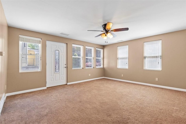 entryway featuring visible vents, carpet, ceiling fan, and baseboards