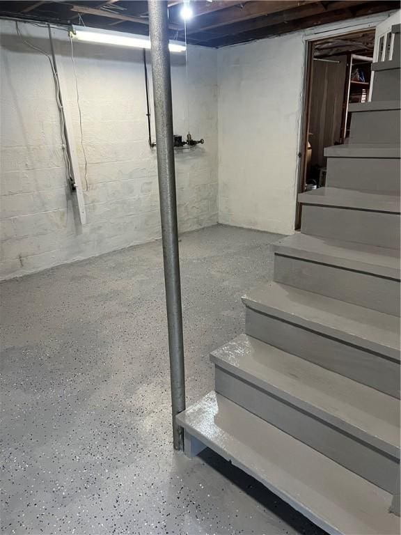unfinished basement featuring stairway
