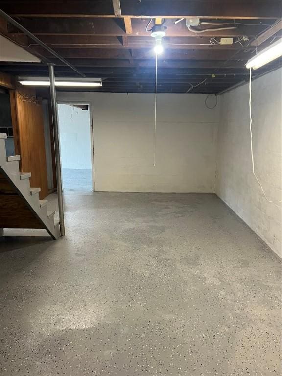 unfinished basement featuring stairway