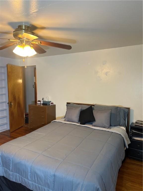 bedroom with a ceiling fan and wood finished floors