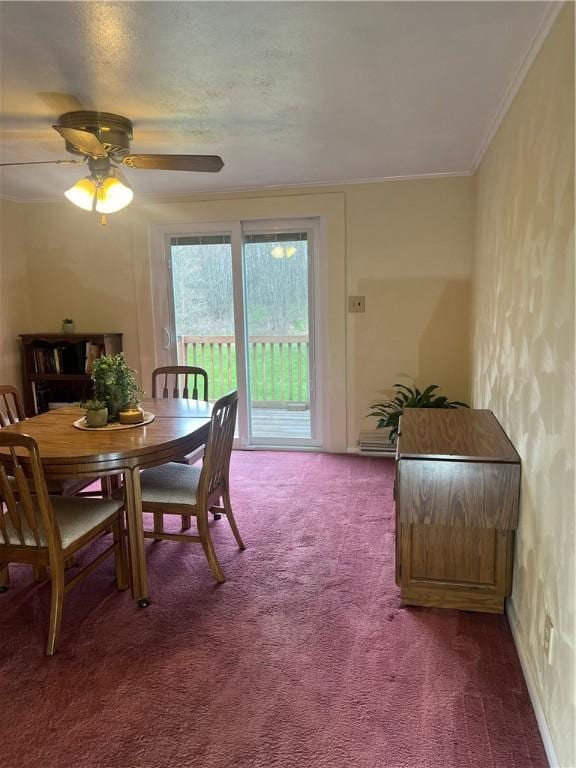 dining space featuring carpet flooring, a ceiling fan, and ornamental molding