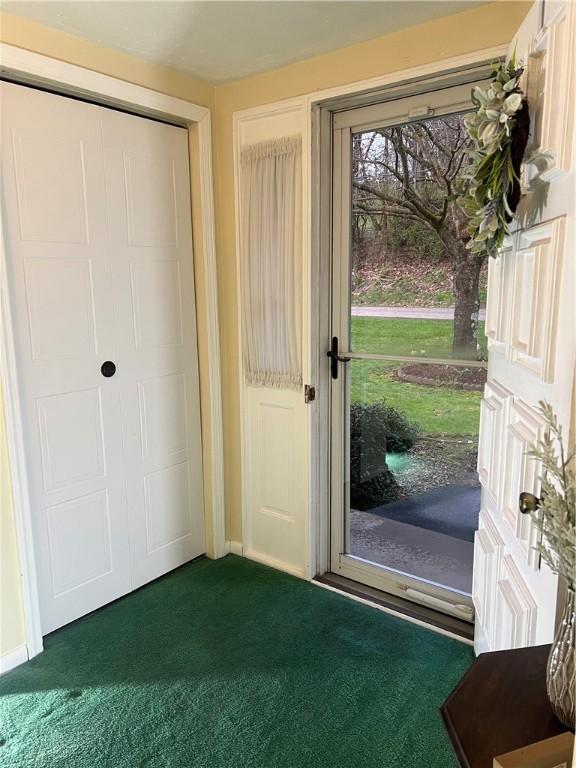 foyer entrance with dark colored carpet