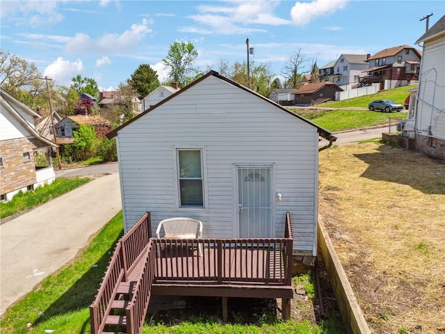 back of property with a residential view and a deck