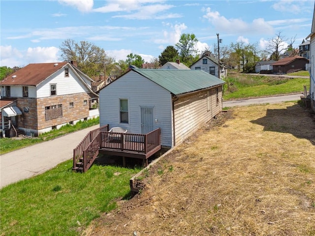 exterior space featuring a yard and a wooden deck