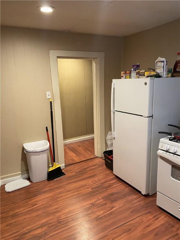 kitchen with white appliances and wood finished floors