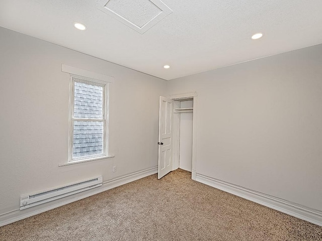 spare room featuring recessed lighting, baseboards, light colored carpet, and a baseboard radiator