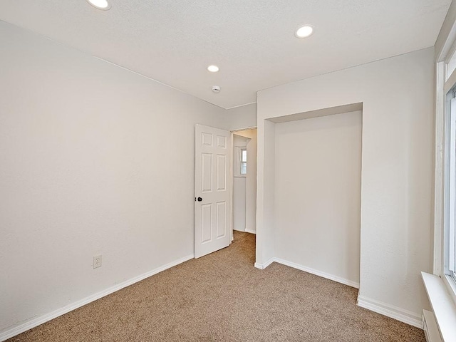 unfurnished bedroom featuring carpet floors, baseboards, and recessed lighting