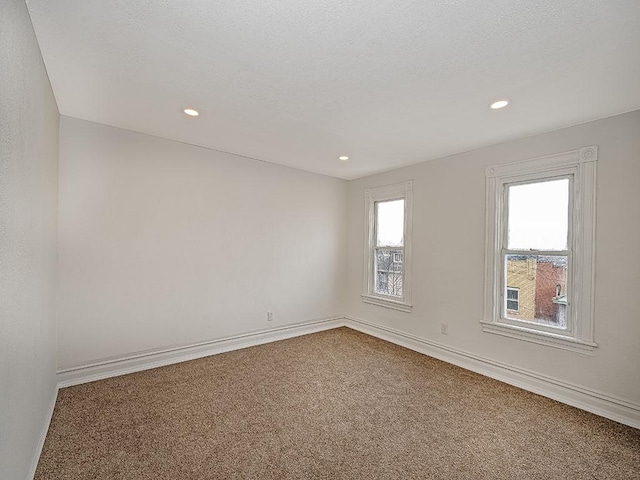 carpeted empty room with recessed lighting and baseboards
