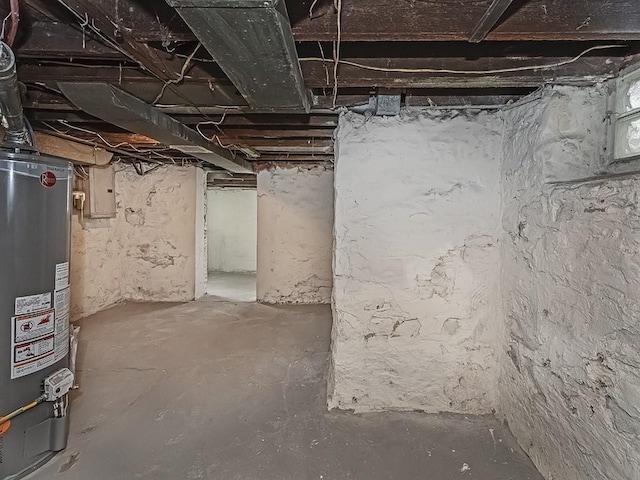 unfinished below grade area with gas water heater and electric panel