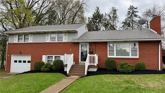 440 School St, Indiana Boro Ind, PA 15701 - tri-level home with a garage, a front yard, a chimney, brick siding, and driveway