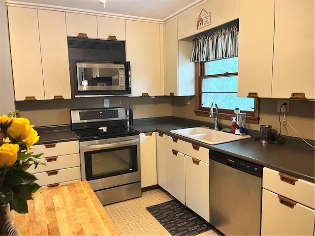 440 School St, Indiana Boro Ind, PA 15701 - kitchen with a sink, dark countertops, stainless steel appliances, and white cabinetry