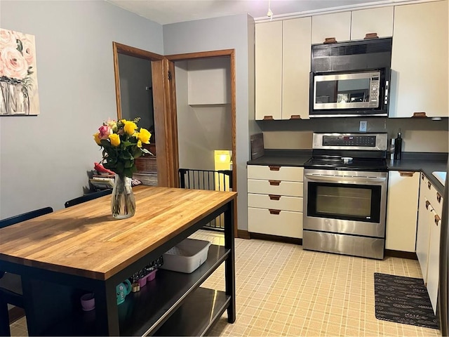 440 School St, Indiana Boro Ind, PA 15701 - kitchen featuring appliances with stainless steel finishes, white cabinets, and butcher block countertops